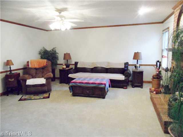 7502 Alcorn Road Greensboro, NC 27409 - Photo 8 of 16 Living Room. The oversized living room offers so much space and a wood burning fireplace.