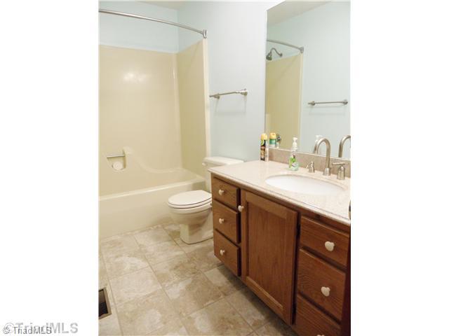 7502 Alcorn Road Greensboro, NC 27409 - Photo 10 of 16 Bath. The guest bath has been newly remodeled with new tile and countertops.