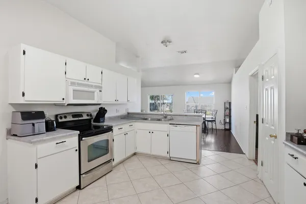 a kitchen with a sink stove and cabinets