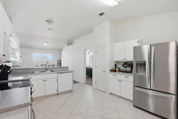 a kitchen with a refrigerator and a sink