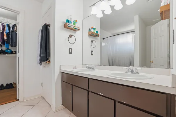 a bathroom with a sink vanity and mirror