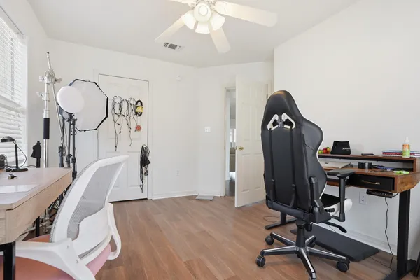 a view of a workspace with furniture and gym equipment