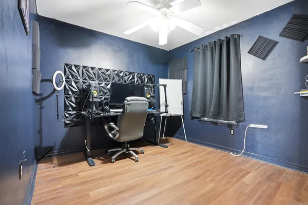 a view of a workspace with furniture and gym equipment