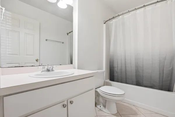 a bathroom with a toilet a sink and a mirror