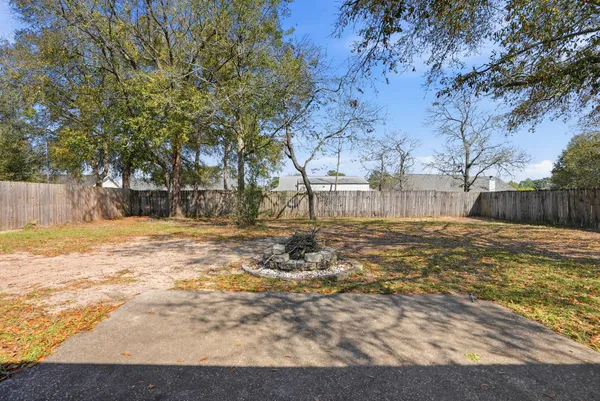 a view of yard with wooden fence
