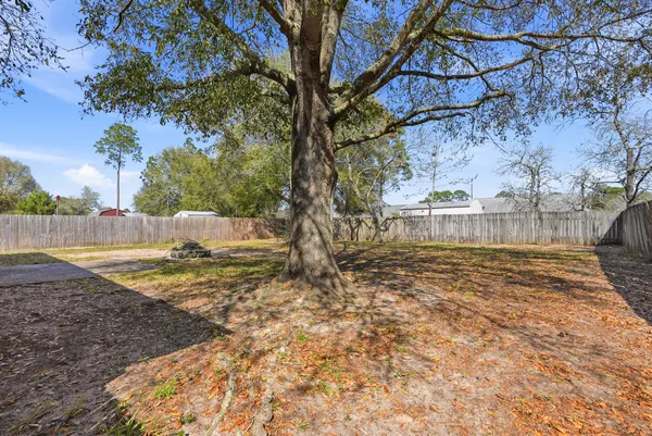 a view of a yard with wooden fence