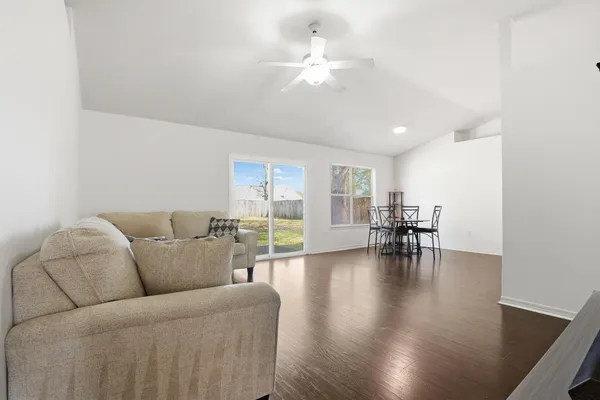 a living room with furniture and wooden floor