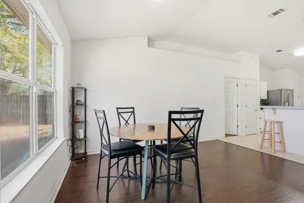 a view of a dining room with furniture and a floor to ceiling window