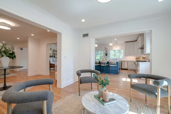 a living room with furniture and a view of kitchen