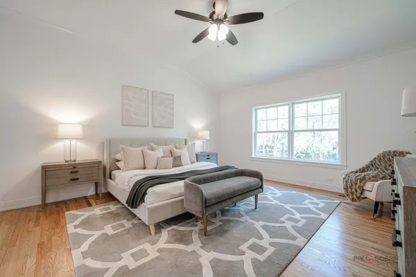 a spacious bedroom with a bed and a window