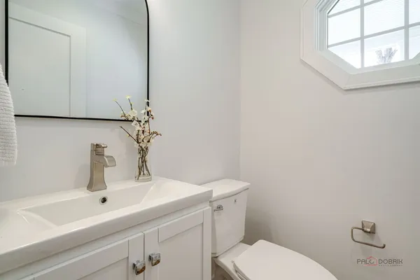 a bathroom with a sink a toilet and mirror