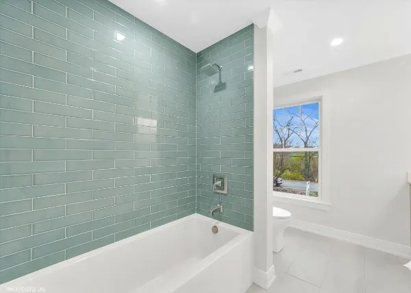 a bathroom with a bathtub and shower
