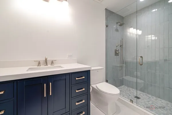 a bathroom with a sink toilet a mirror and shower