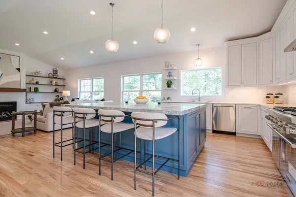 a kitchen with a sink cabinets and wooden floor
