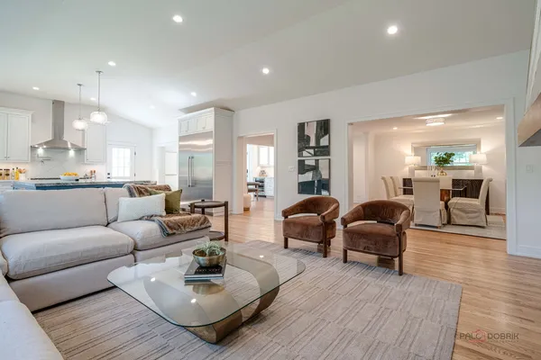 a living room with furniture and view of kitchen