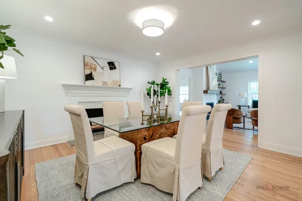 a living room with fireplace furniture and a wooden floor