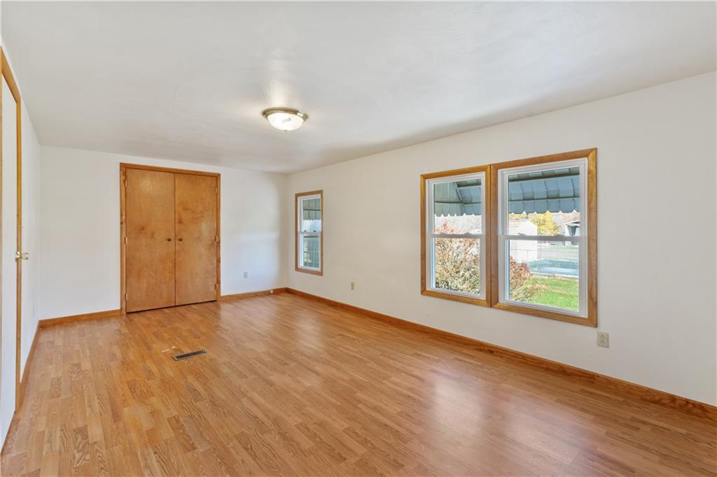 364 Spruce Hollow Road Vandergrift, PA 15690 - Photo 6 of 37 a view of an empty room with wooden floor and windows