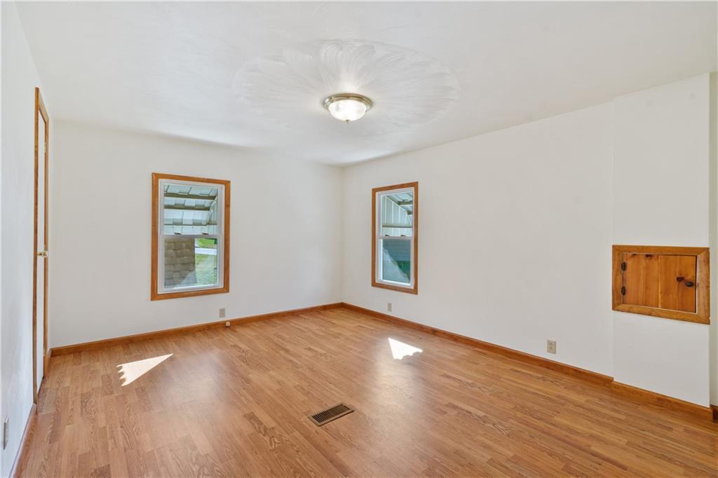 364 Spruce Hollow Road Vandergrift, PA 15690 - Photo 7 of 37 a view of an empty room with wooden floor and a window
