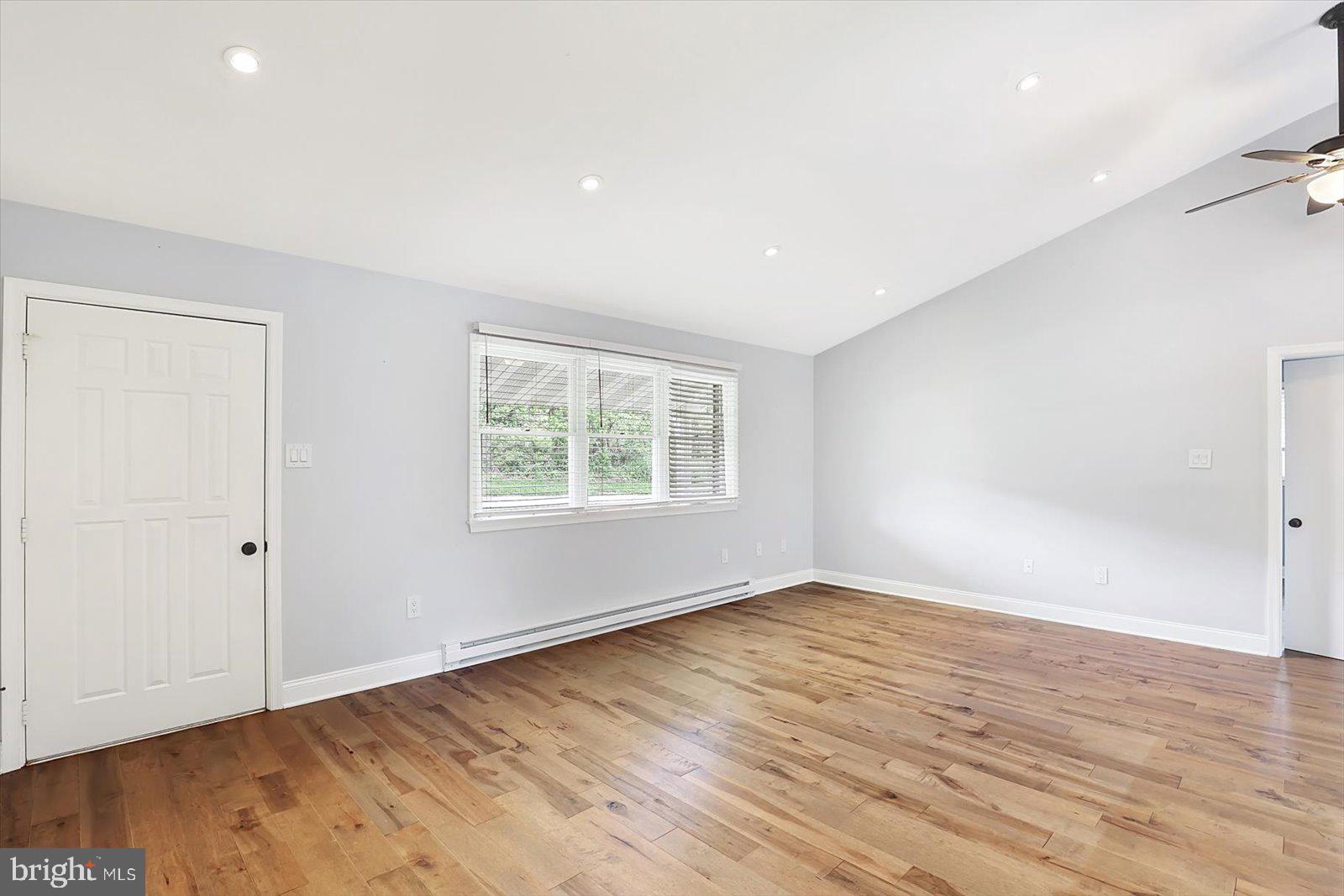 5824 Spruce Road Felton, PA 17322 - Photo 7 of 38 an empty room with wooden floor and windows
