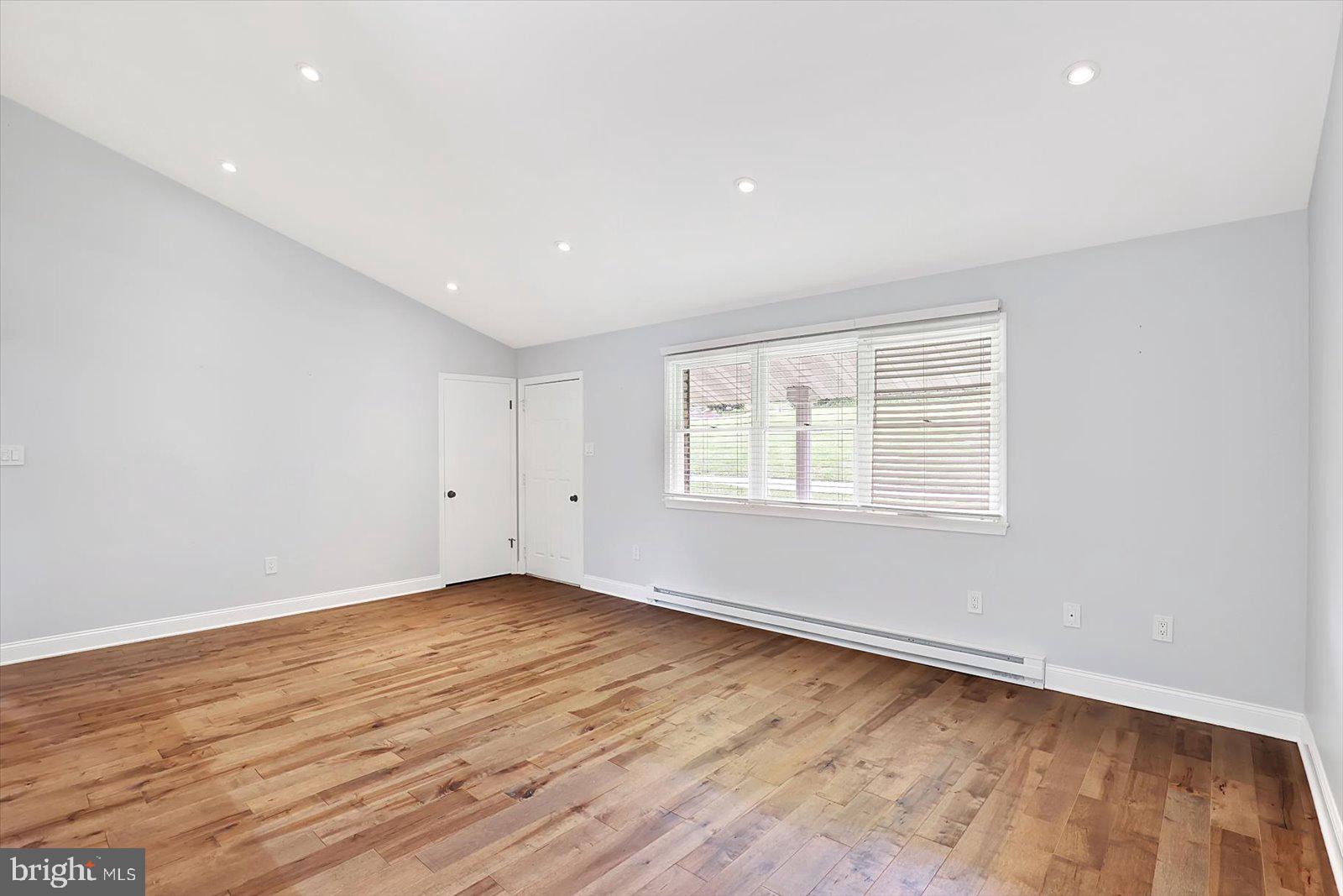 5824 Spruce Road Felton, PA 17322 - Photo 8 of 38 an empty room with wooden floor and windows