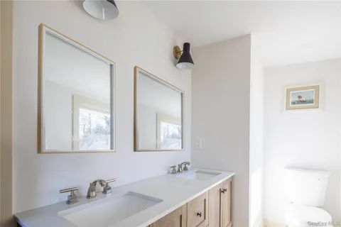 a bathroom with 2 sink and a mirror