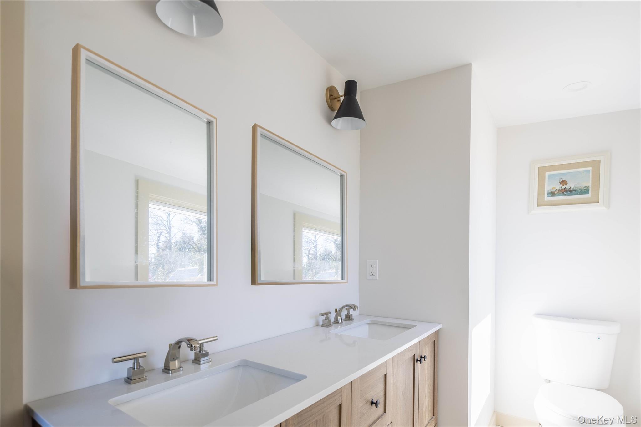 2845 Hobart Road Southold, NY 11971 - Photo 9 of 18 a bathroom with 2 sink and a mirror