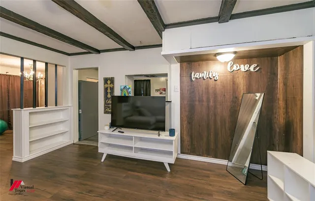 a view of a room with wooden floor and windows