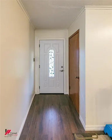 a view of an empty room with wooden floor and closet