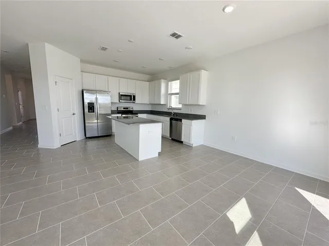 a kitchen with a sink cabinets and stainless steel appliances