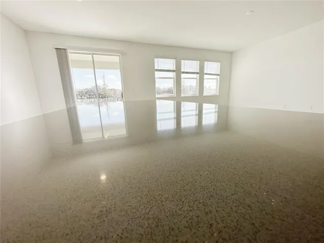 an empty room with a empty space and windows