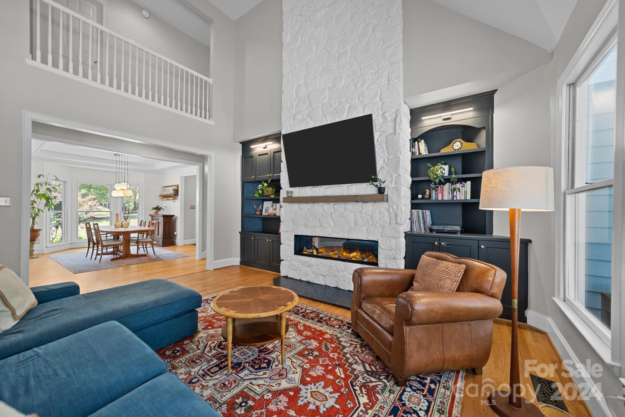 251 Kimberly Road Davidson, NC 28036 - Photo 13 of 47 a living room with furniture a fireplace and a flat screen tv