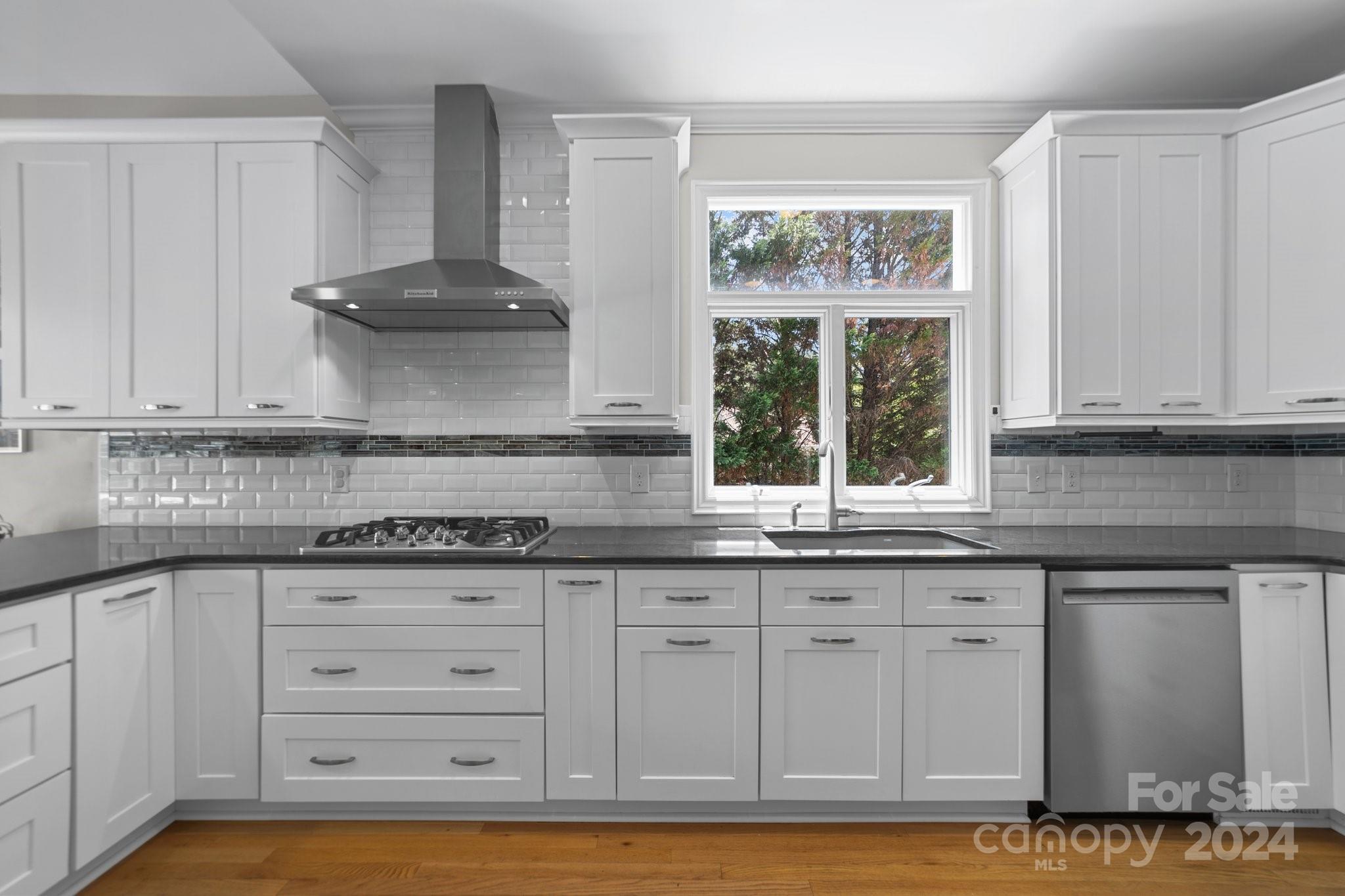 251 Kimberly Road Davidson, NC 28036 - Photo 18 of 47 a kitchen with granite countertop white cabinets and window