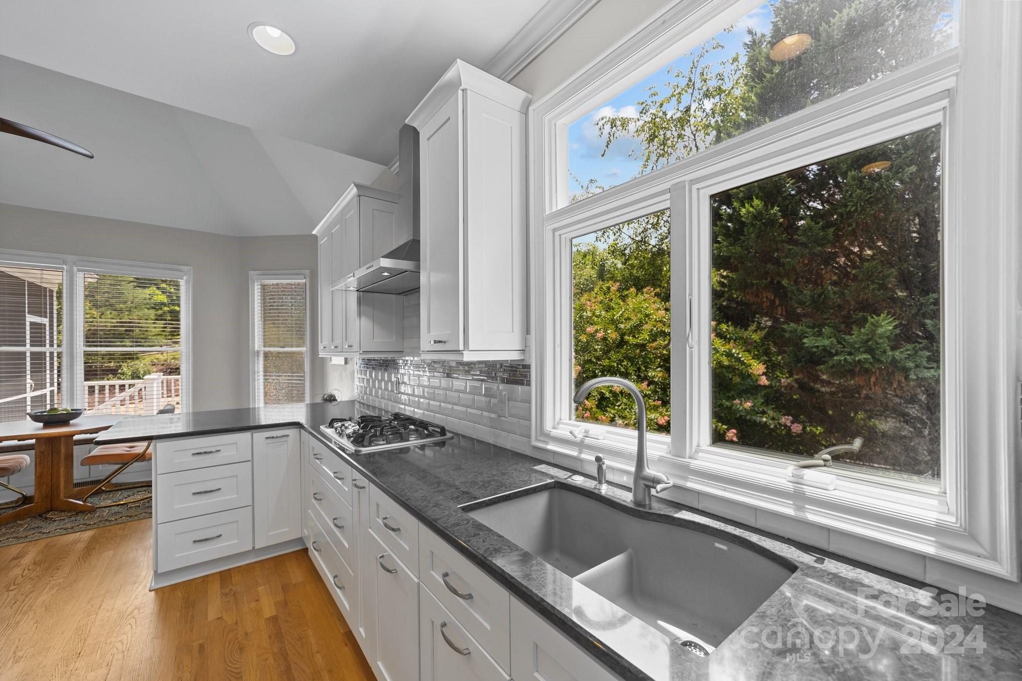 251 Kimberly Road Davidson, NC 28036 - Photo 20 of 47 a kitchen with a sink a counter top space and a large window
