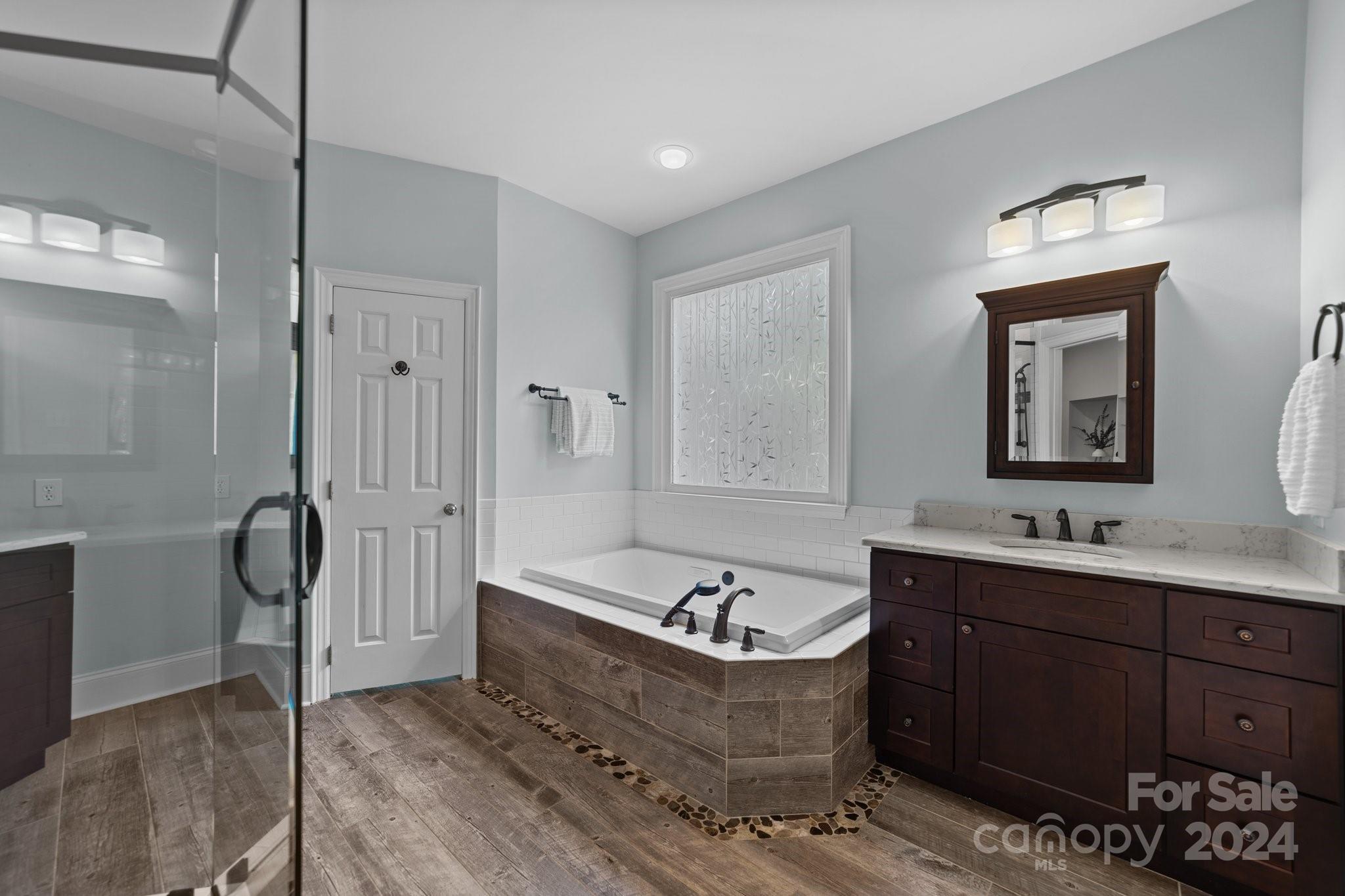 251 Kimberly Road Davidson, NC 28036 - Photo 23 of 47 a bathroom with a tub sink and mirror