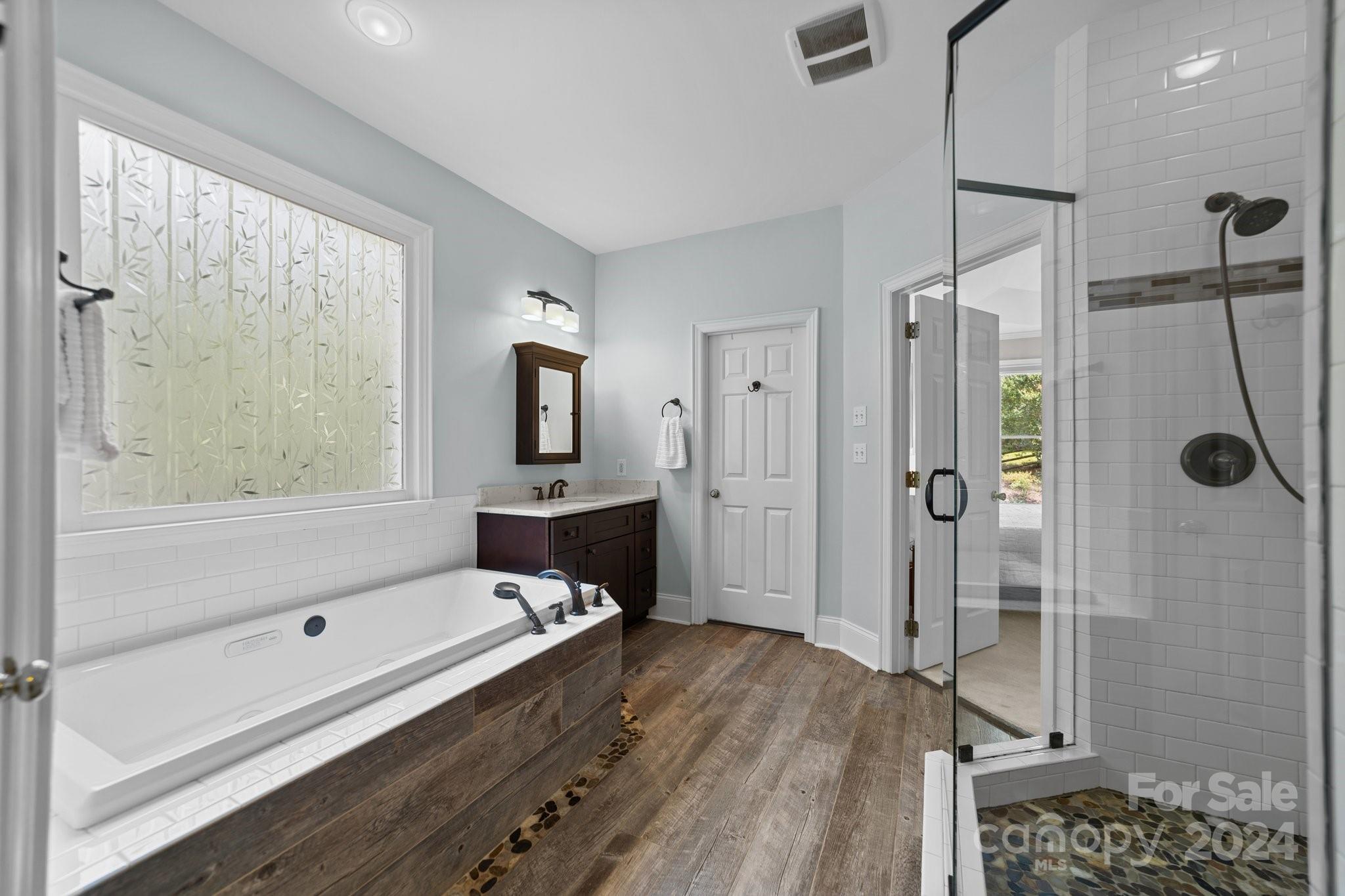 251 Kimberly Road Davidson, NC 28036 - Photo 24 of 47 a bathroom with a tub a window and a shower