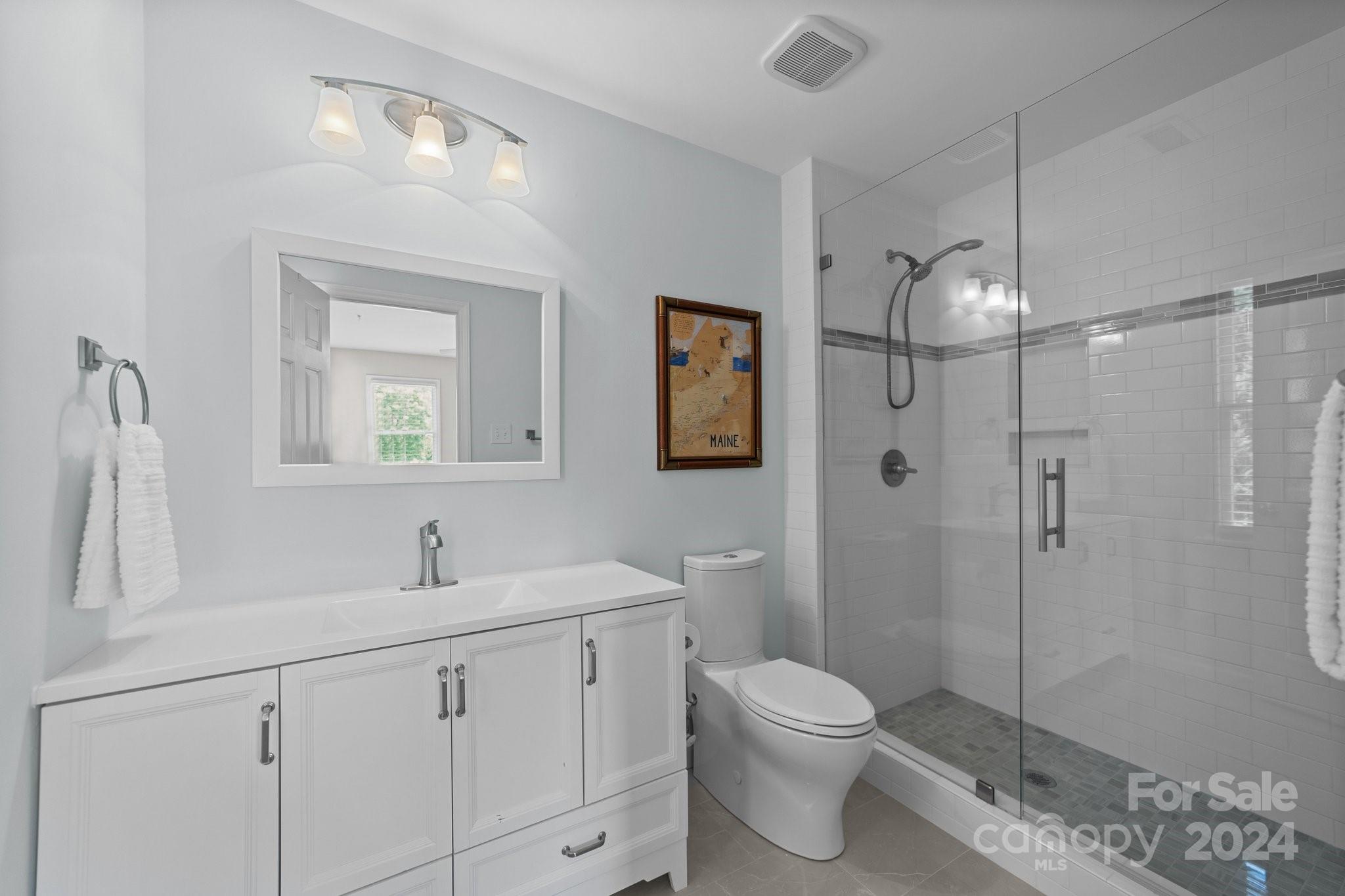 251 Kimberly Road Davidson, NC 28036 - Photo 30 of 47 a bathroom with a toilet sink a shower and vanity