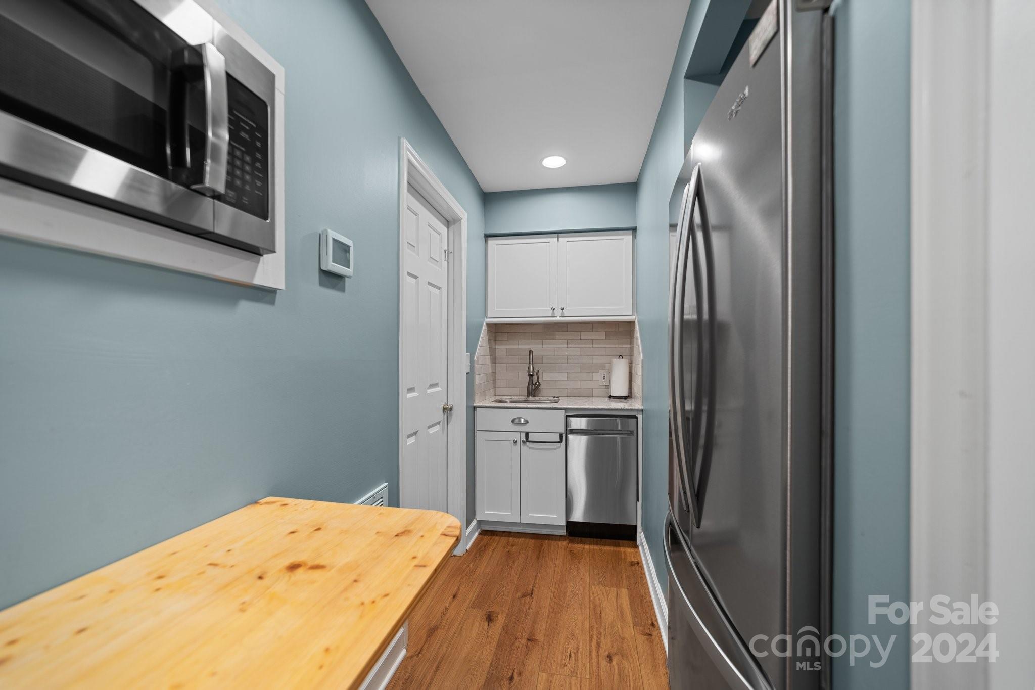 251 Kimberly Road Davidson, NC 28036 - Photo 37 of 47 a kitchen with a refrigerator and a sink
