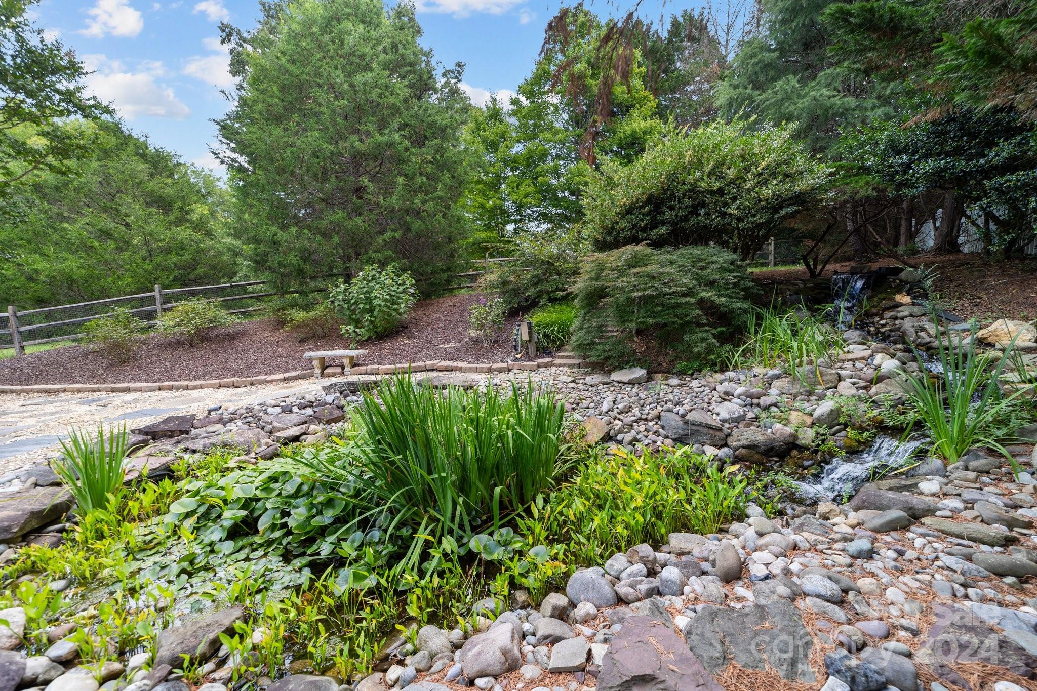 251 Kimberly Road Davidson, NC 28036 - Photo 45 of 47 a view of a garden with plants and large trees