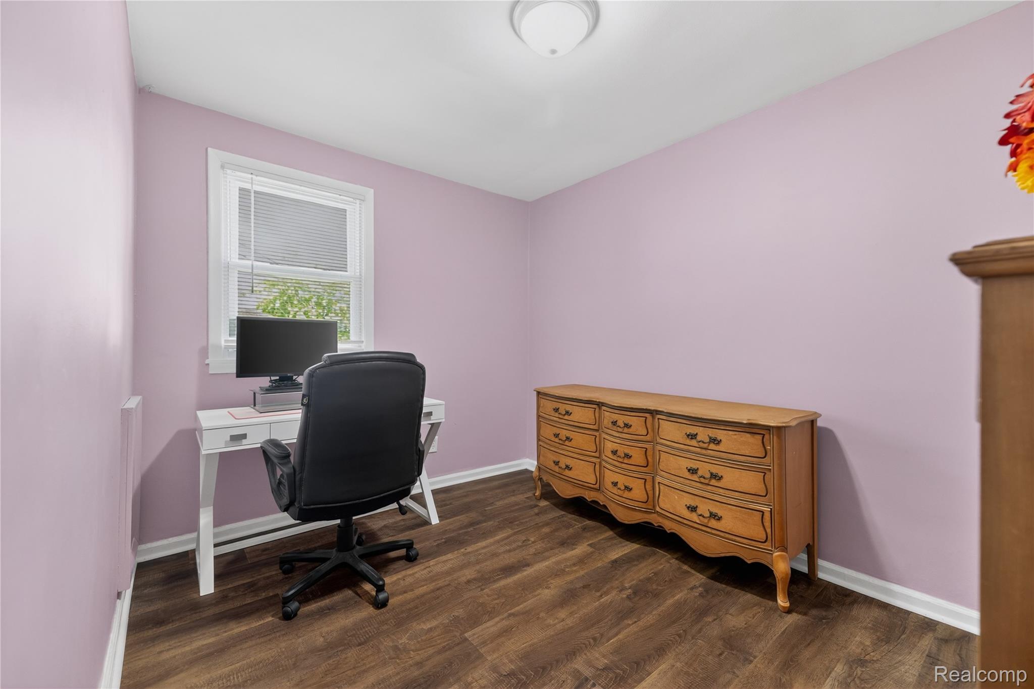 826 Goddard Road Wyandotte, MI 48192 - Photo 21 of 39 Wood-finish flooring with white trim and a single window featuring blinds