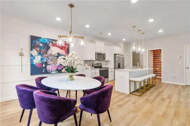 a view of a dining room with furniture kitchen and wooden floor