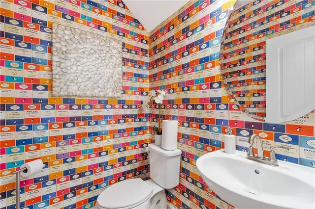a bathroom with a sink a toilet and shower curtain