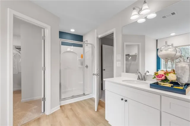 a view of walk in closet with clothes