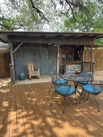 a backyard of a house with table and chairs
