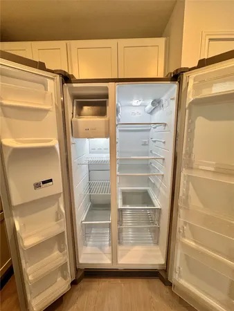 a view of walk in closet with empty racks