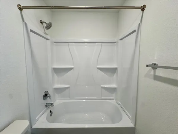 a bathroom with a shower and a bath tub