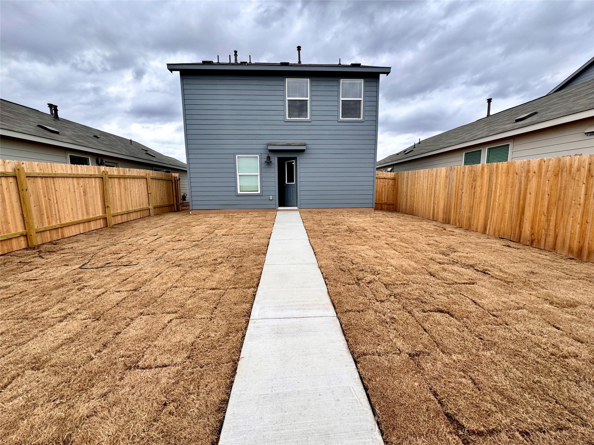 554 Sormonne Loop Kyle, TX 78640 - Photo 32 of 35 Rear view of house with a fenced backyard