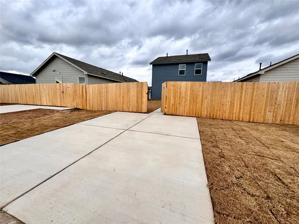 a view of an empty room with wooden fence