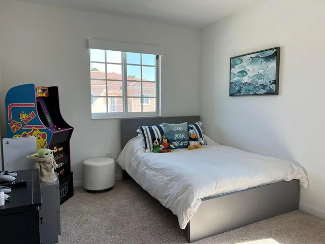 a bedroom with a bed and a window