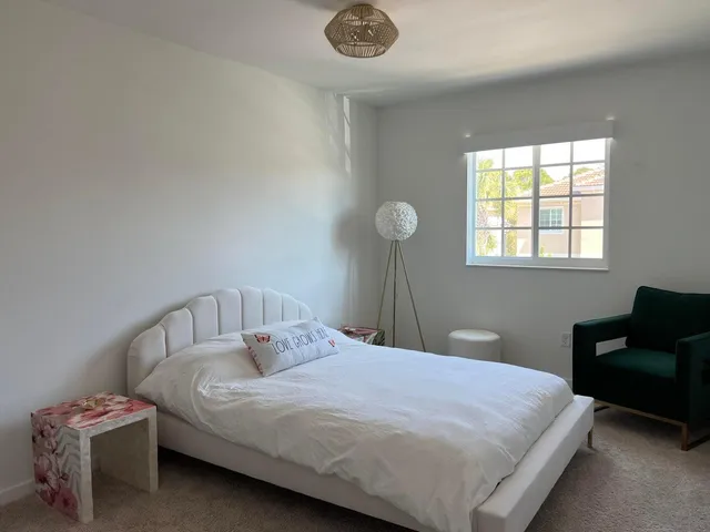 a bedroom with a bed and a chair