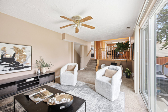 734 Sandy Dunes Drive Sandy, UT 84094 - Photo 15 of 36 Living area featuring light-toned walls, ceiling fan with integrated lighting, and carpet flooring